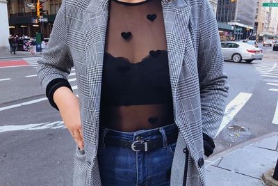 Girl wearing check blazer, black mesh top and black lace Lively bra
