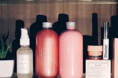 2 pink fob bottles surrounded by beauty products